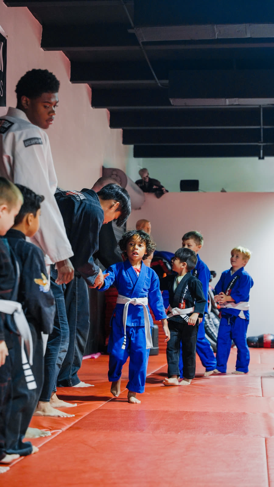 Kids lined up in gis at jiu-jitsu class