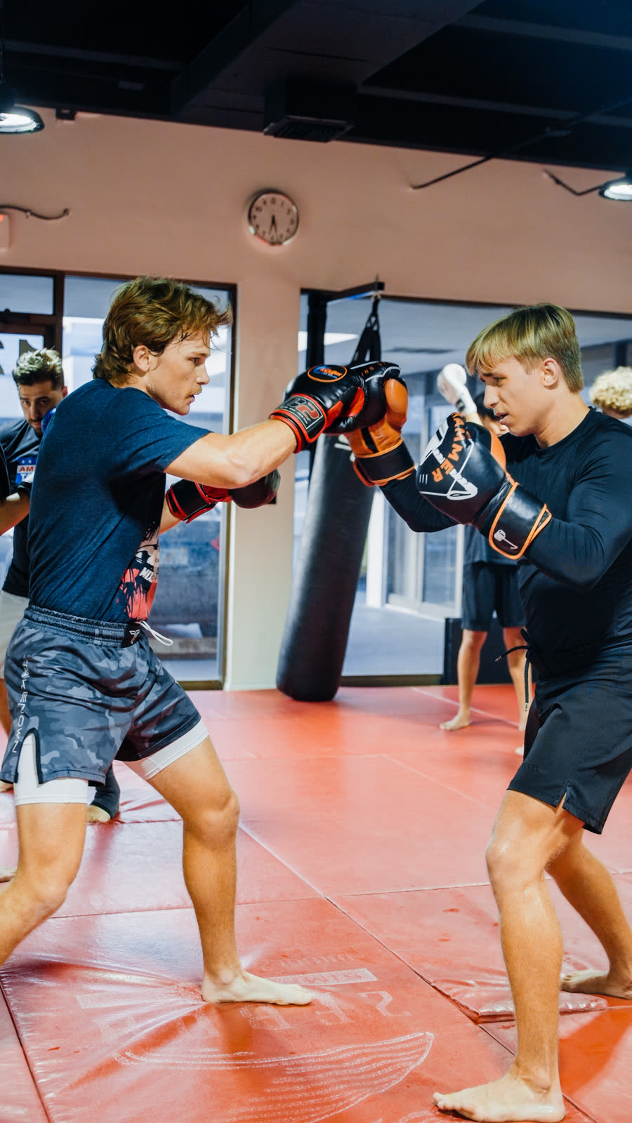 Young athletes boxing with pads