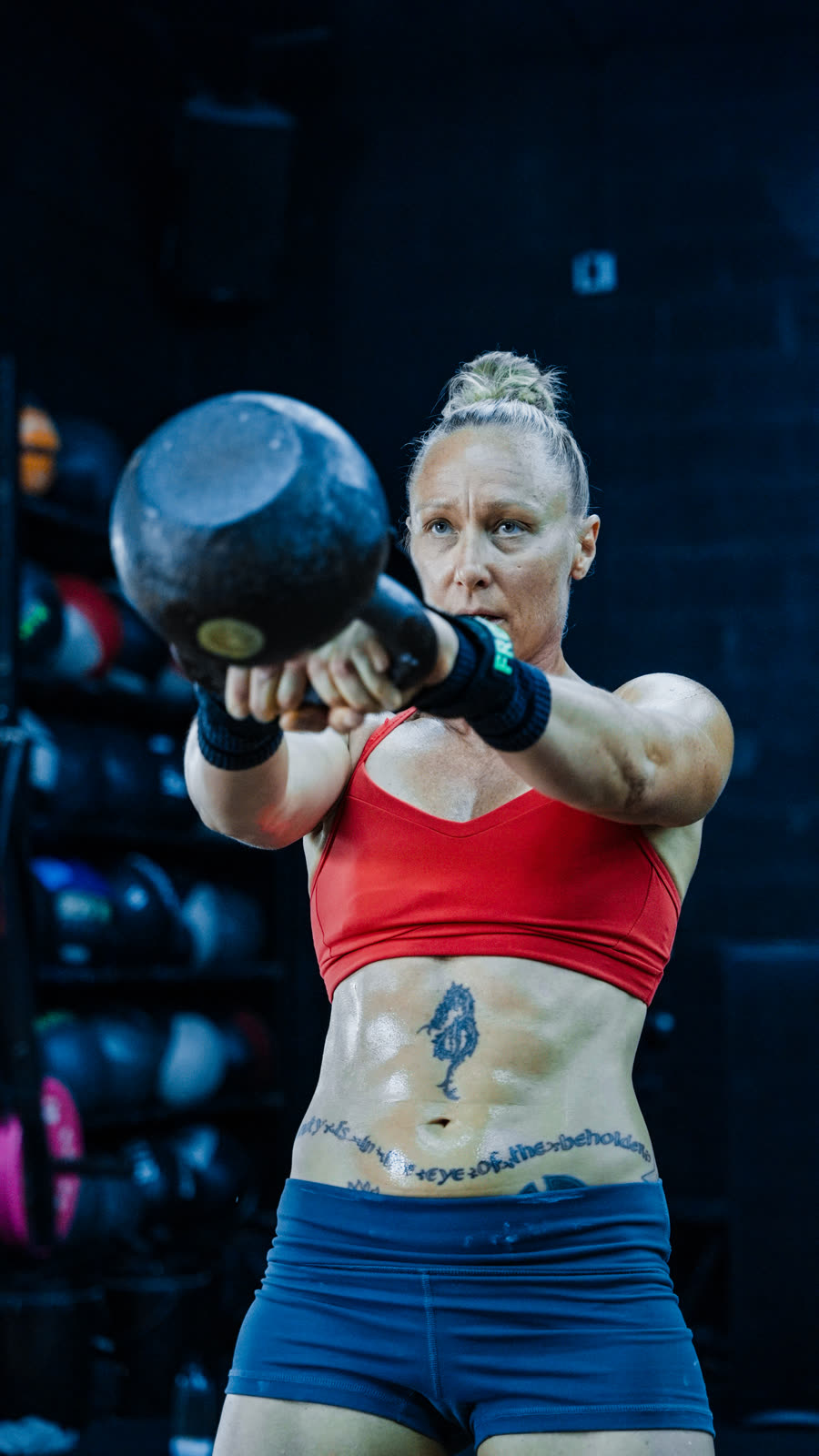 Athlete pressing a kettlebell