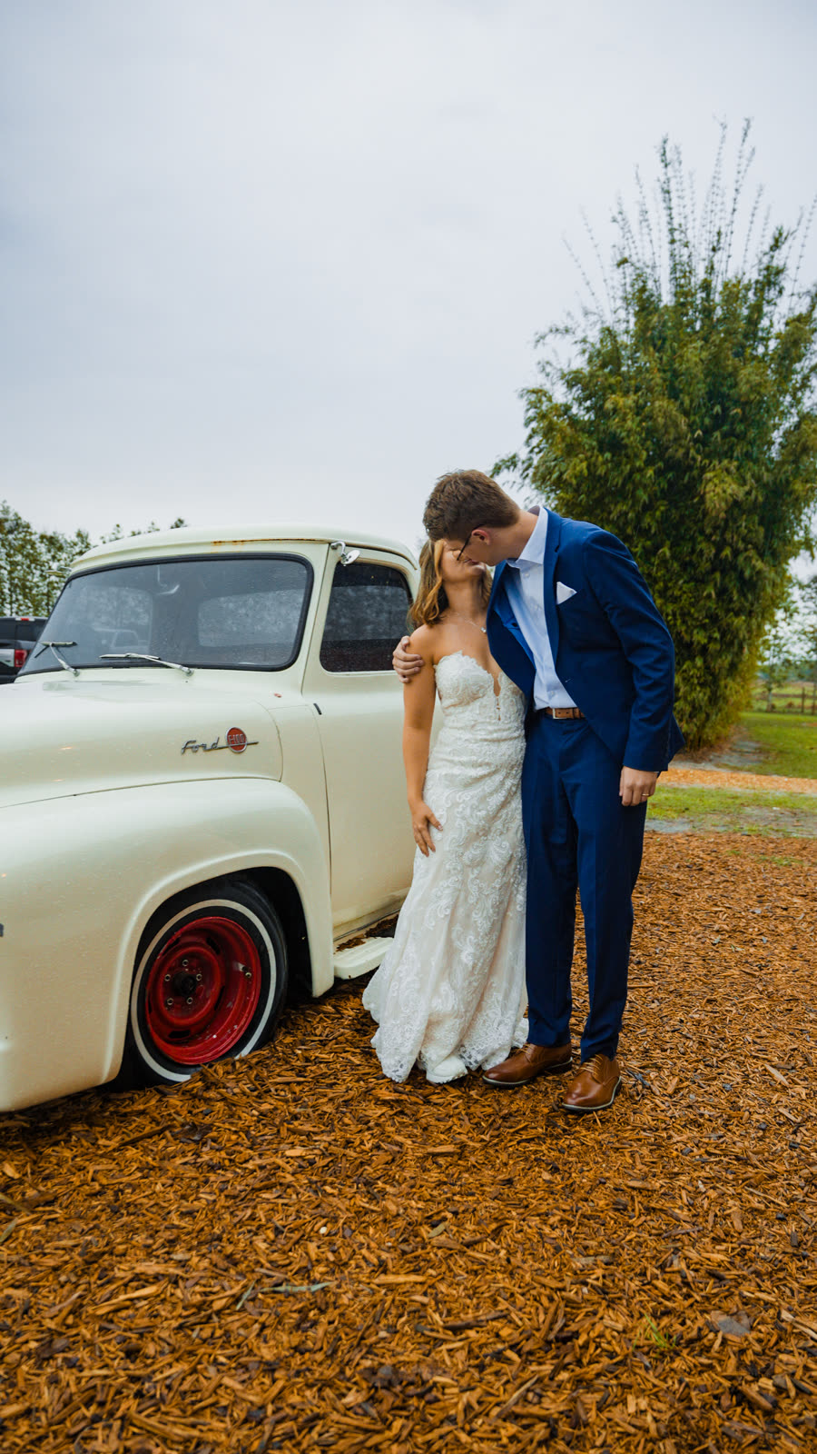 Couple laughing by a vintage truck